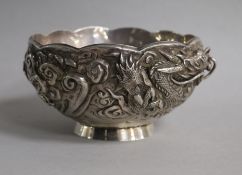 An early 20th century Japanese double skinned white metal bowl, decorated with a dragon, diameter
