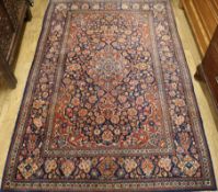 An Isfahan red ground medallion rug 202cm x 133cm