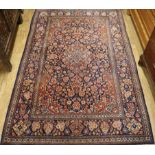 An Isfahan red ground medallion rug 202cm x 133cm