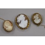 Three assorted mounted cameo brooches including 9ct gold, largest 44mm.