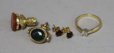 An 18ct gold and solitaire diamond ring, a 9ct gold spinning fob, a pair of 9ct gold ear studs and a