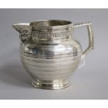 An Edwardian silver jug by Edward Barnard & Sons Ltd, decorated with vineous band and Bacchanalian