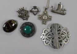 Six assorted silver brooches including Iona and a plated nurse's buckle.