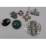 Six assorted silver brooches including Iona and a plated nurse's buckle.