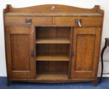 An Arts & Crafts oak bookcase W.137cm