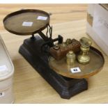 A set of Victorian black painted cast iron scales, with brass pans and weights