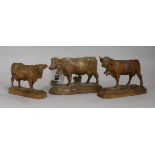 Three Bavarian carved boxwood models of cows with bells