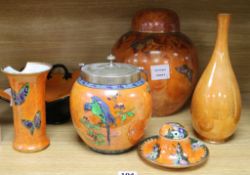 Carlton ware Armand orange lustre - a ginger jar and cover, two vases, an inkwell, biscuit barrel