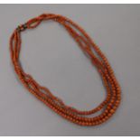 A triple strand graduated coral bead necklace, gross weight 51 grams, 50cm.