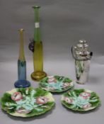 A plated cocktail shaker, plates and two studio glass vases