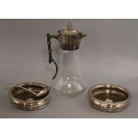 A silver plate mounted claret jug, a pair of silver plated wine coasters and a plated sauce ladle.