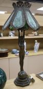 A pair of figural lamps with stained glass shades overall height 96cm