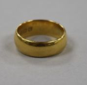 A 22ct gold wedding band, size J.