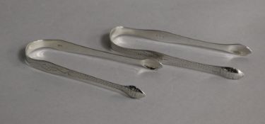 A pair of George III Hester Bateman bright cut engraved silver sugar tongs and a pair of similar