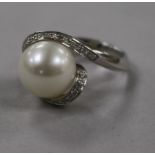 An 18ct white gold, diamond and cultured pearl dress ring, size M.