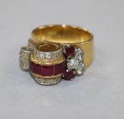 A 1950's? yellow metal, ruby and diamond cocktail ring, size I.