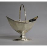 A George III silver panelled boat shaped pedestal sugar basket, London, 1787, length 15.6cm.