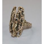 A late 1960's 9ct gold textured ring of rustic form, size L.