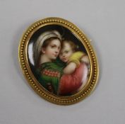 A yellow metal mounted oval plaque brooch, decorated with "Virgin & Child", 41mm.