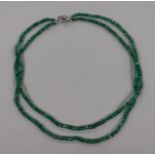 A double strand facet cut emerald bead necklace, with white metal, diamond and cultured pearl set