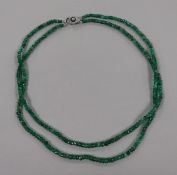 A double strand facet cut emerald bead necklace, with white metal, diamond and cultured pearl set