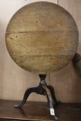 A george III oak tripod table. W.71cm