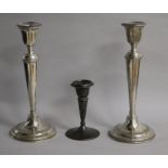 A pair of George V silver candlesticks, William Hutton & Sons, Birmingham, 1914/5 and one other