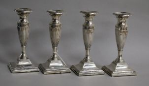 A set of four Edwardian fluted silver candlesticks, Marks & Cohen, Birmingham, 1906, weighted, 16.