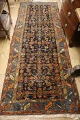 A Caucasian black ground hall carpet 294 x 105cm