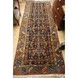 A Caucasian black ground hall carpet 294 x 105cm