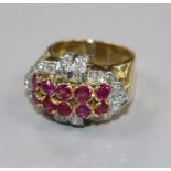 A yellow metal, ruby and diamond cluster dress ring, size O.