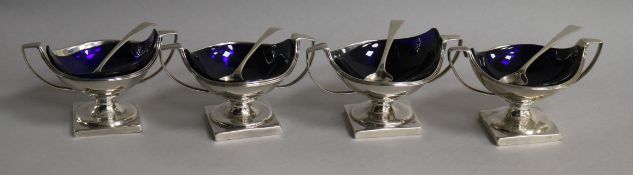 A matched set of four (two pairs) George III silver two handled circular pedestal salts, Peter,