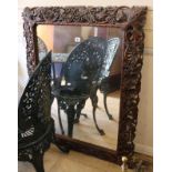 A carved oak framed mirror W.83cm