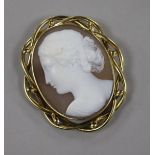 A yellow metal mounted oval cameo brooch, carved with the bust of a lady to dexter, 67mm.