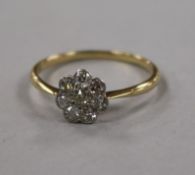 A yellow metal and diamond cluster flower head ring, size S.