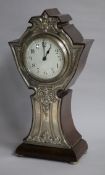 An early 20th century silver mounted mantel timepiece, Birmingham 1909, the shaped wooden case