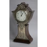 An early 20th century silver mounted mantel timepiece, Birmingham 1909, the shaped wooden case