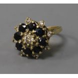 A yellow metal sapphire and diamond cluster ring, size P.