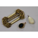 An ornate gilt metal buckle and 9ct gold mounted fob and a pendant.