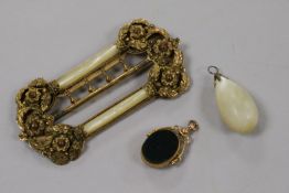 An ornate gilt metal buckle and 9ct gold mounted fob and a pendant.