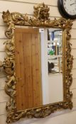 A gilt painted carved wood mirror W.69cm
