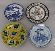 A Delft plate, an armorial plate and two others