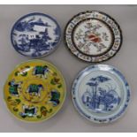 A Delft plate, an armorial plate and two others