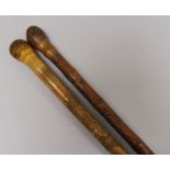 Two Oriental carved walking sticks Longest 90cm.