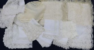 Various 19th century and later handmade lace trimmed hankies and a silk hankie sachet and baby