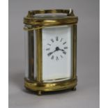 A late 19th century French oval brass cased miniature eight day carriage timepiece height 22cm