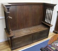 An Arts & Crafts oak settle W.159cm