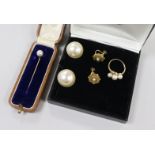 A 9ct gold and triple cultured pearl ring, a pair of gold and pearl earclips, a pair of simulated