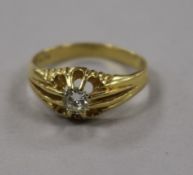 An 18ct gold and claw set solitaire diamond ring, size T.