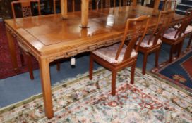 A Chinese hardwood extending dining table, with 2 spare leaves W.275cm